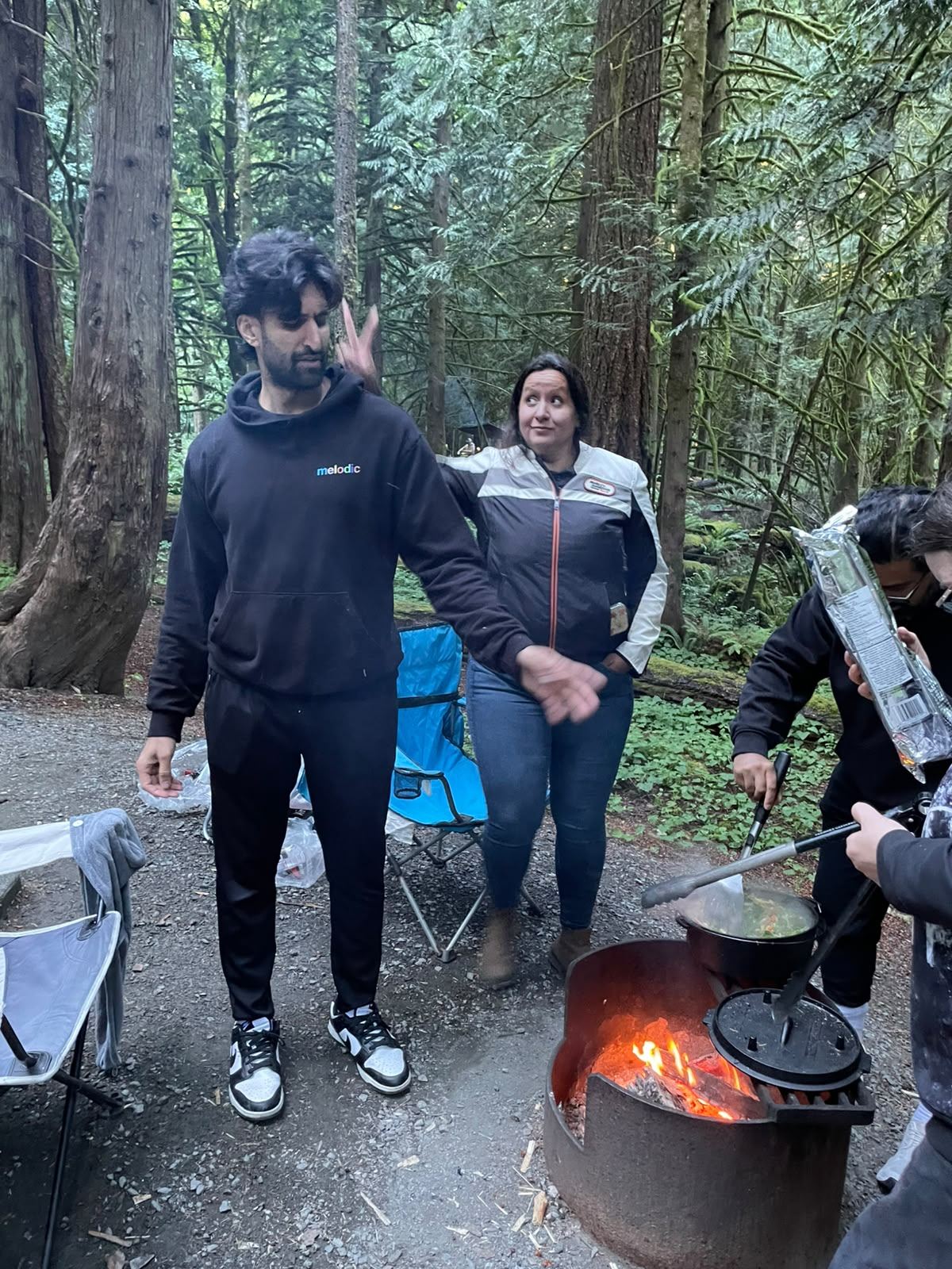 Members standing near the firepit at the cookout