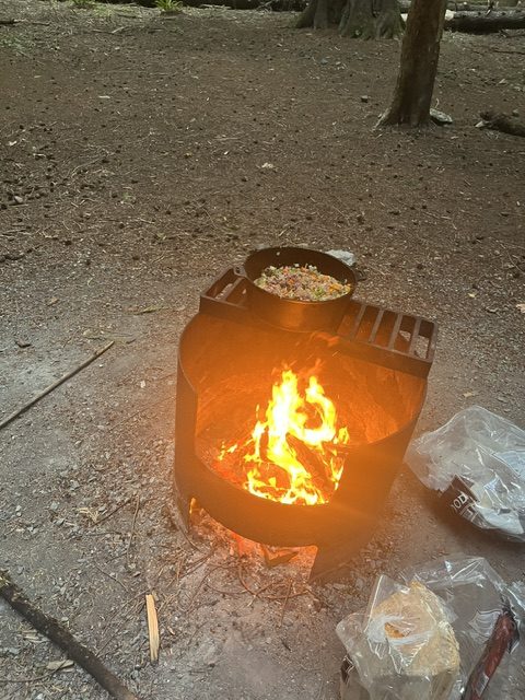 The chili cooking over the fire as the light starts to fade